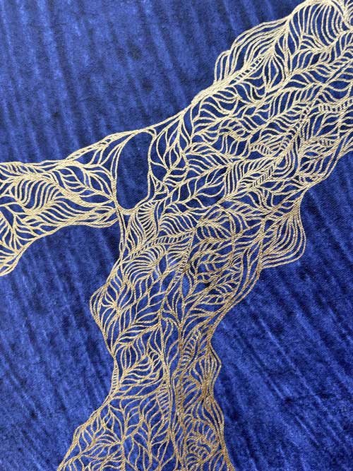 Detail of drawing inspired by gnarly tree trunks and branches in the Turia park in Valencia, Spain. Silver and gold acrylic markers on heavily textured indigo blue handmade paper.