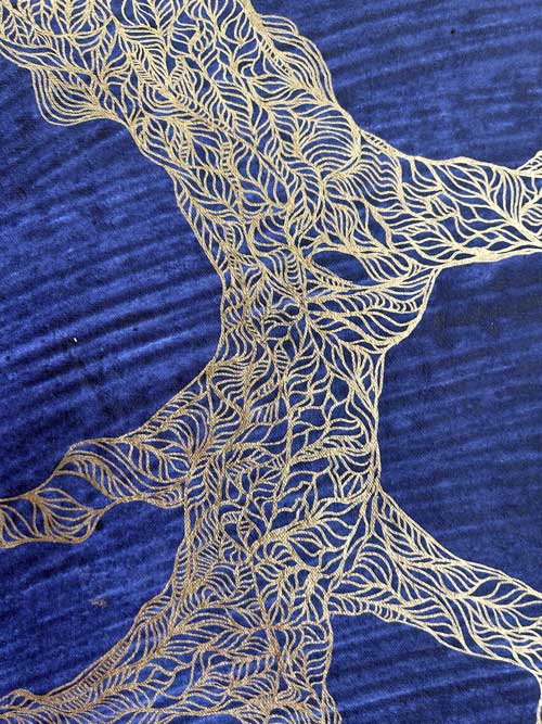 Detail of drawing inspired by gnarly tree trunks and branches in the Turia park in Valencia, Spain. Silver and gold acrylic markers on heavily textured indigo blue handmade paper.