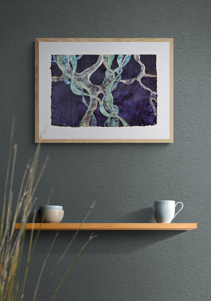 Abstract painting representing Posidonia Oceanica, a Mediterranean weed, framed and hanging on a sage green wall, above a wooden shelf..